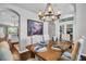 Spacious dining room features wood table with place settings, arched doorways, and hanging chandelier at 12918 Tar Flower Dr., Tampa, FL 33626