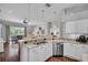 Bright kitchen with stainless steel appliances, granite countertops, and an island with a breakfast bar, open to the living room at 12918 Tar Flower Dr., Tampa, FL 33626