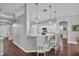 Spacious kitchen with an island breakfast bar illuminated by pendant lights and three chairs at 12918 Tar Flower Dr., Tampa, FL 33626