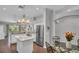 Open kitchen and dining area featuring granite countertops, island, stainless appliances, and pendant lighting at 12918 Tar Flower Dr., Tampa, FL 33626