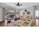 Cozy living room with a view of the pool through large windows and decorative wall hangings at 12918 Tar Flower Dr., Tampa, FL 33626