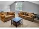 Cozy living room with two sofas, a coffee table, and a window offering natural light and a comfortable ambiance at 12918 Tar Flower Dr., Tampa, FL 33626