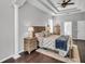 Inviting main bedroom boasts tray ceilings, rich hardwood floors, decorative columns and neutral colors at 12918 Tar Flower Dr., Tampa, FL 33626