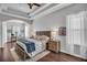Spacious main bedroom featuring tray ceilings, wood floors, elegant furnishings, and large windows at 12918 Tar Flower Dr., Tampa, FL 33626
