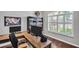 Bright home office with a large desk, comfortable chair, and a window with plantation shutters at 12918 Tar Flower Dr., Tampa, FL 33626