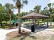 Beautiful park featuring a covered picnic area, playground, and lush landscaping at 12918 Tar Flower Dr., Tampa, FL 33626