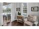 Cozy sitting area with a view of the pool through sliding glass doors and a window at 12918 Tar Flower Dr., Tampa, FL 33626