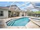 Inviting screened-in pool with a spa and outdoor patio, perfect for relaxing and entertaining in a private backyard oasis at 12918 Tar Flower Dr., Tampa, FL 33626