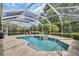 Relaxing screened-in pool with a spa, waterfall feature, and ample patio space for lounging and entertaining at 12918 Tar Flower Dr., Tampa, FL 33626