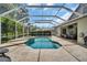 Inviting screened-in pool with spa and outdoor patio, perfect for relaxation and entertainment at 12918 Tar Flower Dr., Tampa, FL 33626