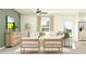 Bright living room with ample seating, modern furnishings, and a view into a full kitchen at 13118 Empress Jewel Trl, Parrish, FL 34219