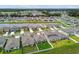 Great aerial of homes and lawns, complemented by a serene pond at 13235 Palmerston Rd, Riverview, FL 33579