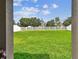 Green backyard with a white fence viewed from a covered patio at 13235 Palmerston Rd, Riverview, FL 33579