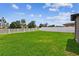 Large, well-maintained backyard with lush green lawn, and white fencing for privacy at 13235 Palmerston Rd, Riverview, FL 33579
