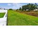 View of backyard featuring healthy green lawn and drainage area on property's edge at 13235 Palmerston Rd, Riverview, FL 33579