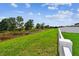 Lush green backyard with a white fence and scenic view of natural landscaping at 13235 Palmerston Rd, Riverview, FL 33579