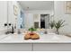 Bathroom featuring double sinks with quartz countertop, white cabinets, and greenery accents for a fresh feel at 13235 Palmerston Rd, Riverview, FL 33579
