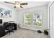 Bedroom with a ceiling fan, natural light from the windows, and a world map on the wall for inspiration at 13235 Palmerston Rd, Riverview, FL 33579