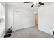 Bright bedroom featuring a ceiling fan, a closet for storage, and an entryway to another area of the house at 13235 Palmerston Rd, Riverview, FL 33579