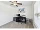 Bedroom with a ceiling fan, a desk, a world map on the wall, and a view of the outdoors through the window at 13235 Palmerston Rd, Riverview, FL 33579