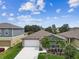 Aerial view of home featuring a two-car garage, lush landscaping, and well-maintained lawn at 13235 Palmerston Rd, Riverview, FL 33579