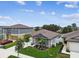 Aerial view of a home showcasing lush landscaping, a two-car garage, and manicured lawn at 13235 Palmerston Rd, Riverview, FL 33579