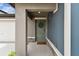 Charming front door featuring a decorative wreath, stone accents, and a 'So Happy You're Here' welcome mat at 13235 Palmerston Rd, Riverview, FL 33579