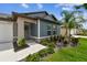 Inviting home exterior with a well-manicured lawn, stone accents, and a charming entryway with beautiful shrubbery at 13235 Palmerston Rd, Riverview, FL 33579