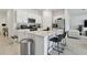 Modern kitchen featuring white cabinets, stainless steel appliances, a large island, and tile floors throughout at 13235 Palmerston Rd, Riverview, FL 33579