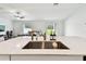 Modern kitchen with stainless steel sink, granite countertops, and open layout to the living room at 13235 Palmerston Rd, Riverview, FL 33579