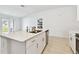 Kitchen island featuring white countertops, stainless steel sink, and modern hardware at 13235 Palmerston Rd, Riverview, FL 33579