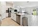 Open-concept kitchen with stainless steel appliances, a central island, and easy access to the living area at 13235 Palmerston Rd, Riverview, FL 33579