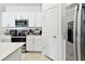 Bright kitchen featuring white cabinets, stainless steel appliances, and modern finishes at 13235 Palmerston Rd, Riverview, FL 33579