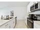 Open kitchen with stainless steel appliances, white cabinets, and views to the bedroom at 13235 Palmerston Rd, Riverview, FL 33579
