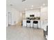 Open concept living area with kitchen featuring stainless steel appliances and white cabinets at 13235 Palmerston Rd, Riverview, FL 33579