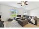 Spacious living room with comfortable seating, rug, and natural light from windows at 13235 Palmerston Rd, Riverview, FL 33579