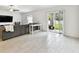 Bright living room featuring a sliding glass door leading to the outdoor patio and white tile floors at 13235 Palmerston Rd, Riverview, FL 33579