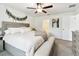 A spacious main bedroom featuring neutral tones, a ceiling fan, and an ensuite bathroom for added convenience at 13235 Palmerston Rd, Riverview, FL 33579