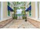 Framed view of the community pool with a decorative gate surrounded by palm trees and lush landscaping at 13235 Palmerston Rd, Riverview, FL 33579