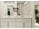 Bright bathroom featuring a double sink vanity with modern faucets and decorative vase with plant sprigs at 13539 White Gold Run, Parrish, FL 34219