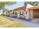 Inviting single-story villa featuring a charming front patio and an American flag for added curb appeal at 1371 Mission Hills Blvd, Clearwater, FL 33759