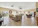 Spacious living room with tile flooring, sofas, ceiling fan, and natural light at 1371 Mission Hills Blvd, Clearwater, FL 33759