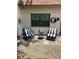 Cozy patio featuring comfortable black and white striped chairs, perfect for enjoying outdoor relaxation at 1371 Mission Hills Blvd, Clearwater, FL 33759