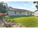 Back exterior with a spacious yard and lush green grass at 15123 Bald Eagle St, Tampa, FL 33625