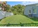 Well-maintained backyard with healthy grass, full fencing, and mature trees at 15123 Bald Eagle St, Tampa, FL 33625