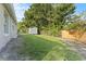 Large backyard with healthy green grass, perimeter fencing, and storage shed at 15123 Bald Eagle St, Tampa, FL 33625