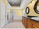 Large bathroom features a shower, tub, double sinks, decorative mirrors, and white tile floors at 15123 Bald Eagle St, Tampa, FL 33625