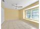 Bedroom with natural light, neutral walls, tile flooring, and ceiling fan at 15123 Bald Eagle St, Tampa, FL 33625