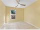 Well-lit bedroom features neutral tile floor and a ceiling fan at 15123 Bald Eagle St, Tampa, FL 33625