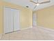 Bedroom with tile floor, neutral walls, a ceiling fan, and large closet at 15123 Bald Eagle St, Tampa, FL 33625